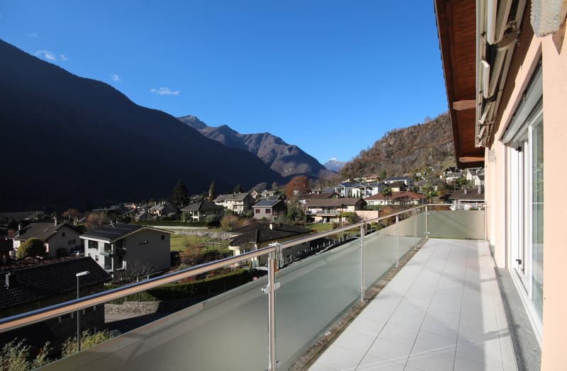 modern balcony with panoramic view of valley, glass railings, tiled floor