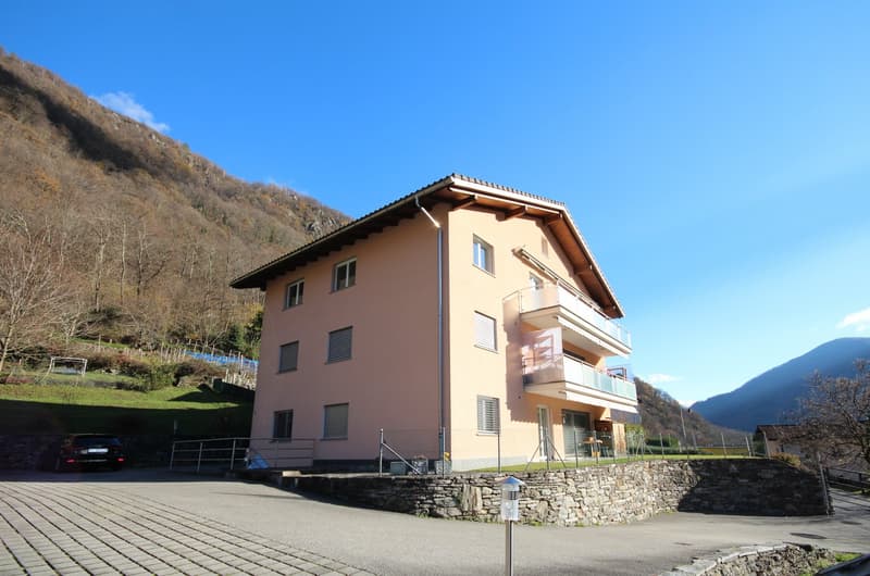 3 story house, pink exterior, balcony, stone wall, car parked in front