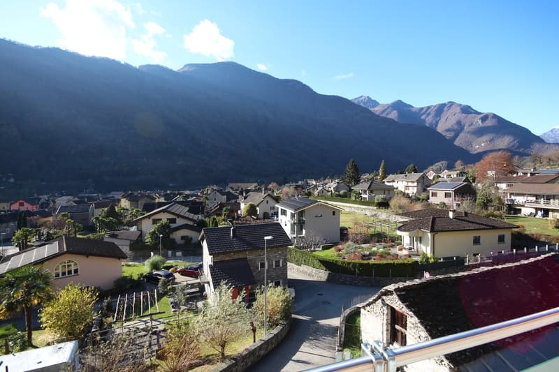 village of houses in the valley with mountains in the background