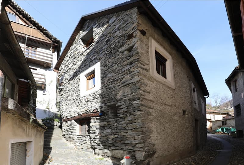 Stone house, 3 windows, wooden balcony, stone wall, narrow street