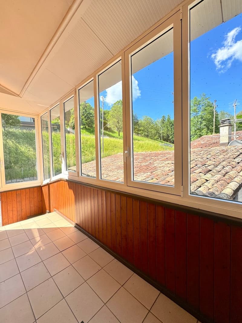 wooden walls, large windows, tile flooring, no furniture, clear view of the surroundings