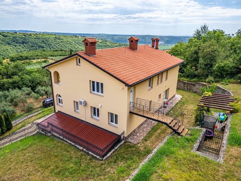 2 story house, beige exterior, red roof, balcony, black fence, car parked