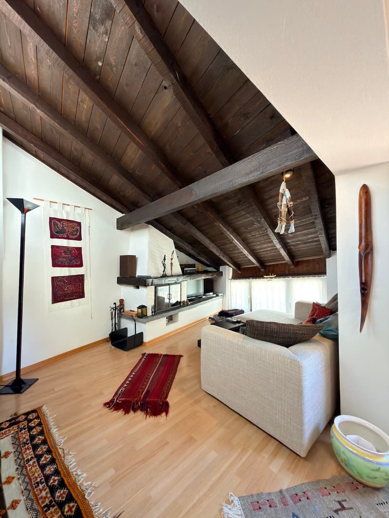 wooden ceiling, fireplace, white walls, wooden floor, couch, rug, lamp, decorative items