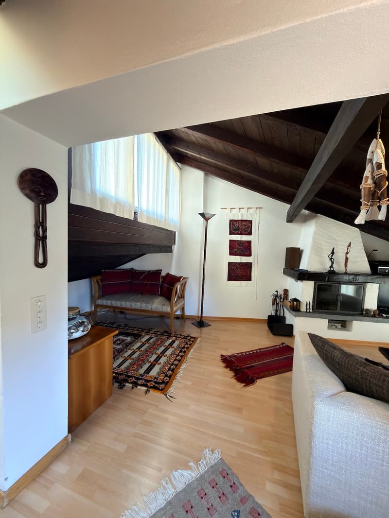wooden floor, fireplace, couch, rug, lamp, wooden cabinet, decorative items