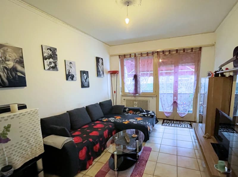 couch, coffee table, television, wall decorations, window