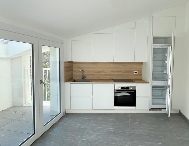 modern kitchen with white cabinetry, wooden countertop, sink, oven, fridge, tile flooring, sliding glass door