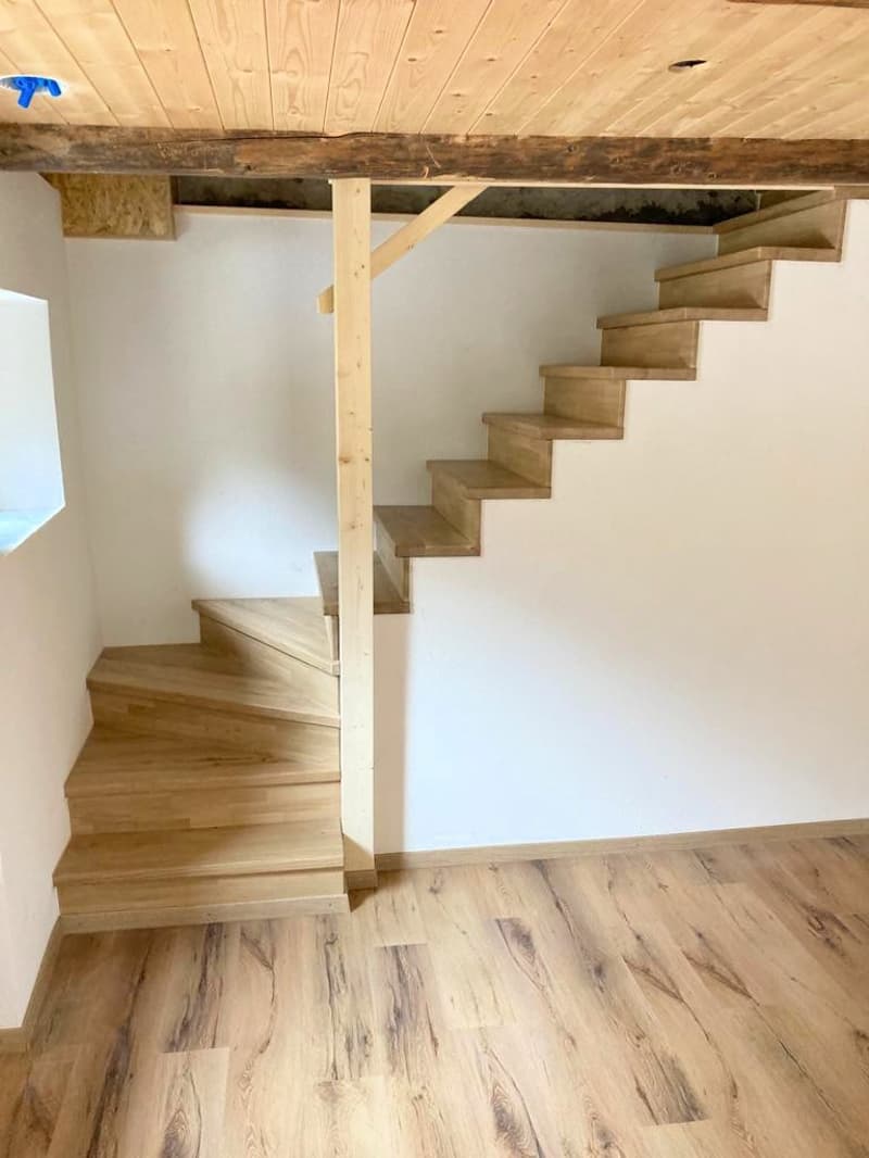 room with wooden floor and staircase