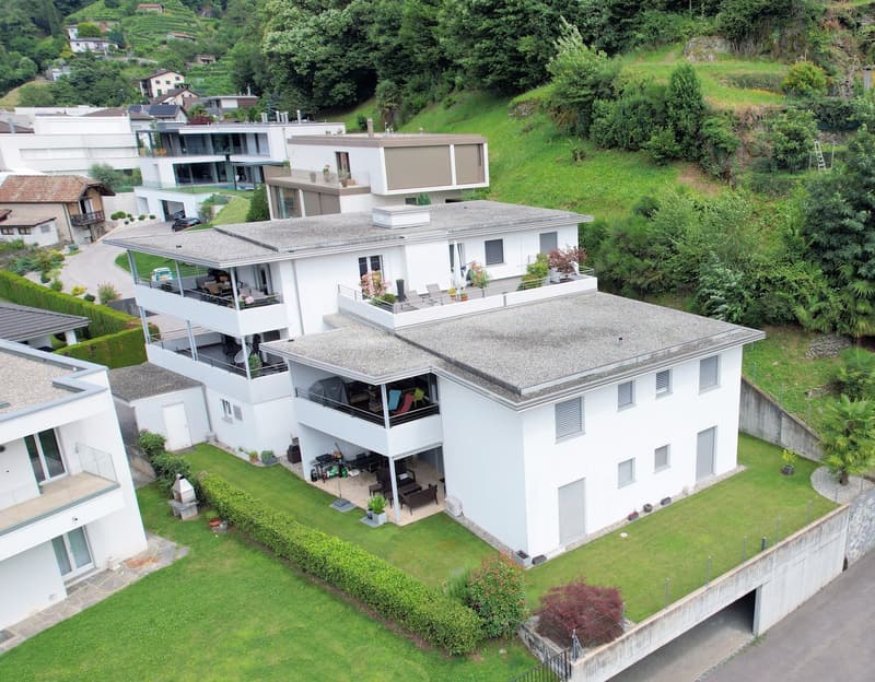 multi-storey house, white exterior, multiple balconies, garden, green surroundings