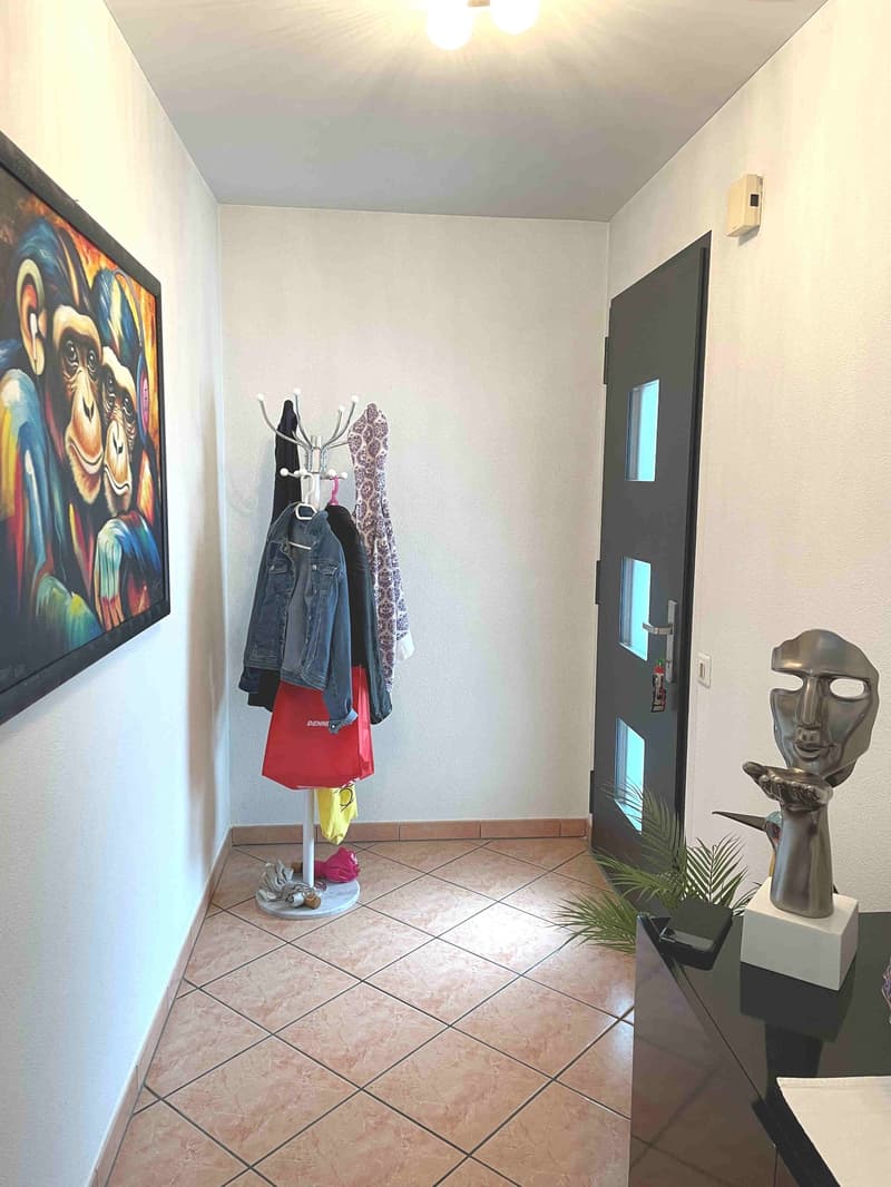 Painting, coat rack, clothes, statue, door, floor tiles