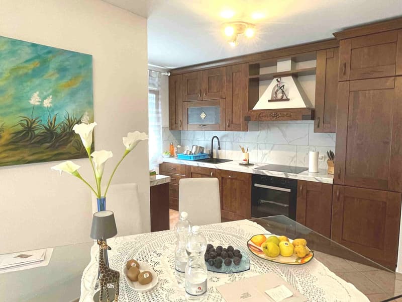 Modern kitchen with granite countertops, built-in cabinets, and appliances.