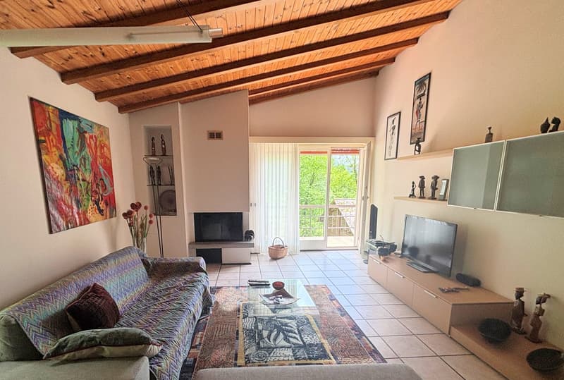 wooden ceiling, decorative fireplace, white tile floor, carpet, rug, couches, coffee table, media console, framed pictures, artwork, two TV's, basket, sliding glass doors, balcony