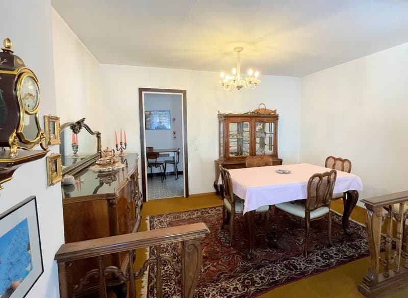 dining room with wooden table and chairs, chandelier, wooden cabinet, mirror, chandelier