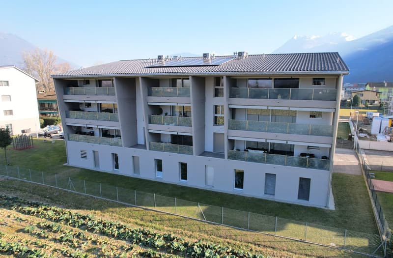 4 story building, solar panels on the roof, balconies on each floor, fenced yard