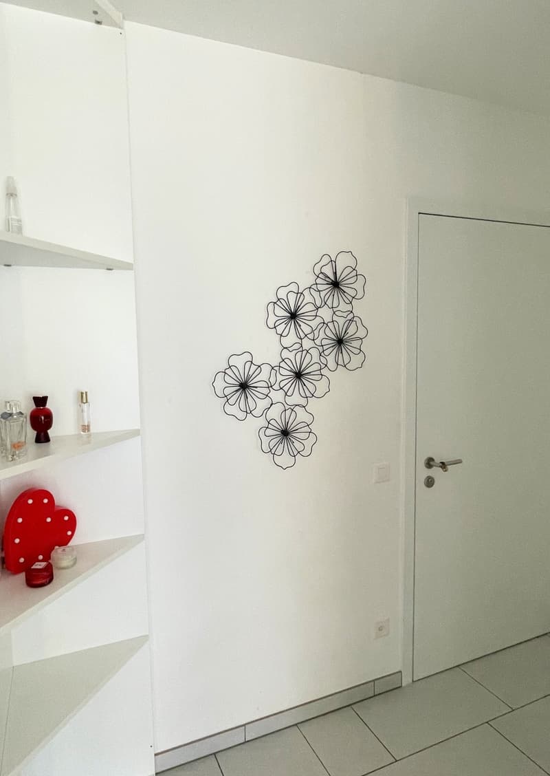 white wall, white shelves, wall art, door, tiled floor