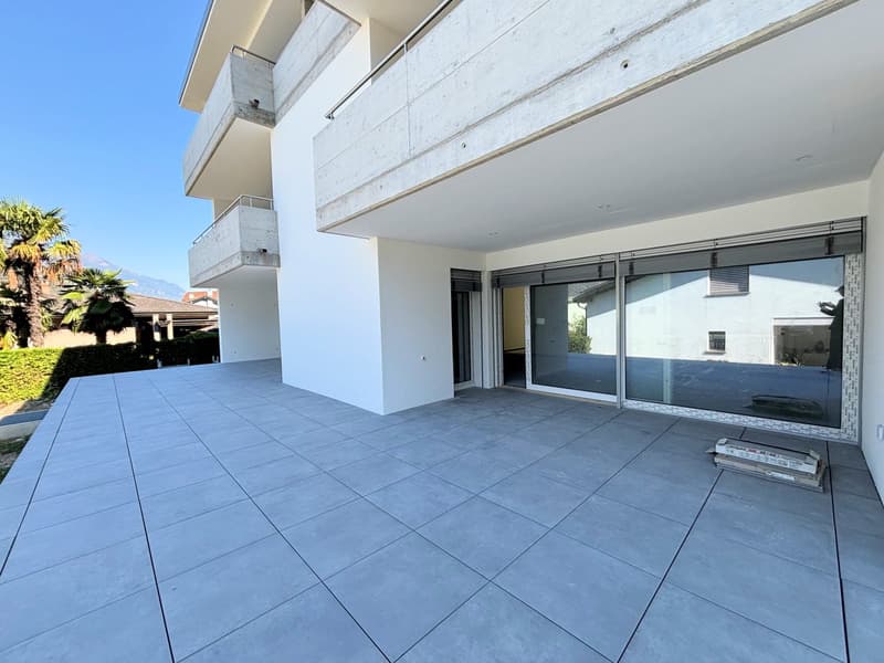 modern building, white exterior, large glass doors, balcony, tiled floor