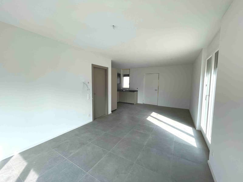 Empty room with white walls, gray tiles, two doors, and a window.