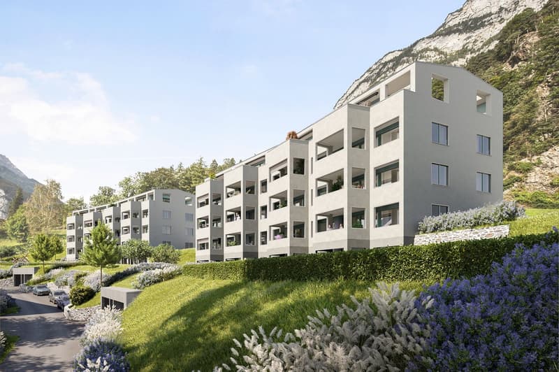 modern multi-story building with balconies and raised ground floor with underground parking