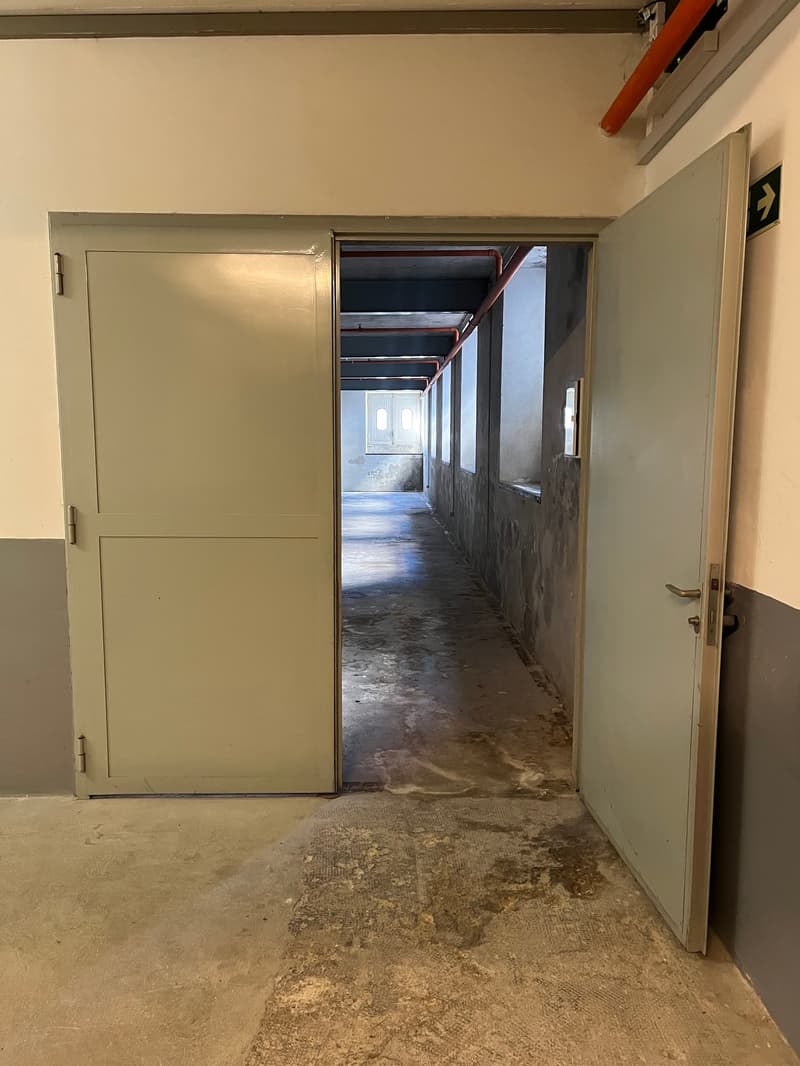 open door, empty hallway, concrete floor, metal beam
