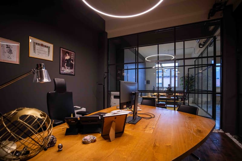 office desk, chairs, monitors, framed photos, decorative items