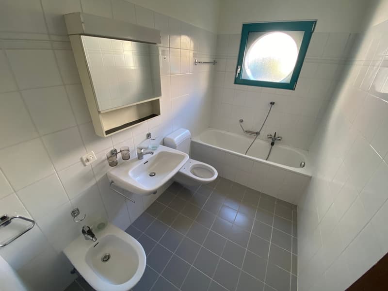 white ceramic tiles, white bathtub, toilet, sink, mirror, window