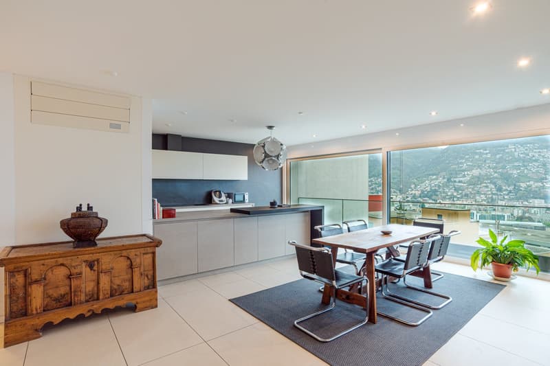 modern open plan living space with a kitchen, dining area and sitting area