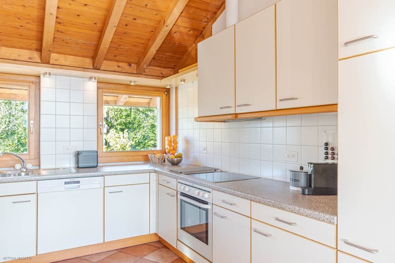 white kitchen, modern design, ceramic floor, dishwasher, washing machine, granite countertop, wooden ceiling, windows