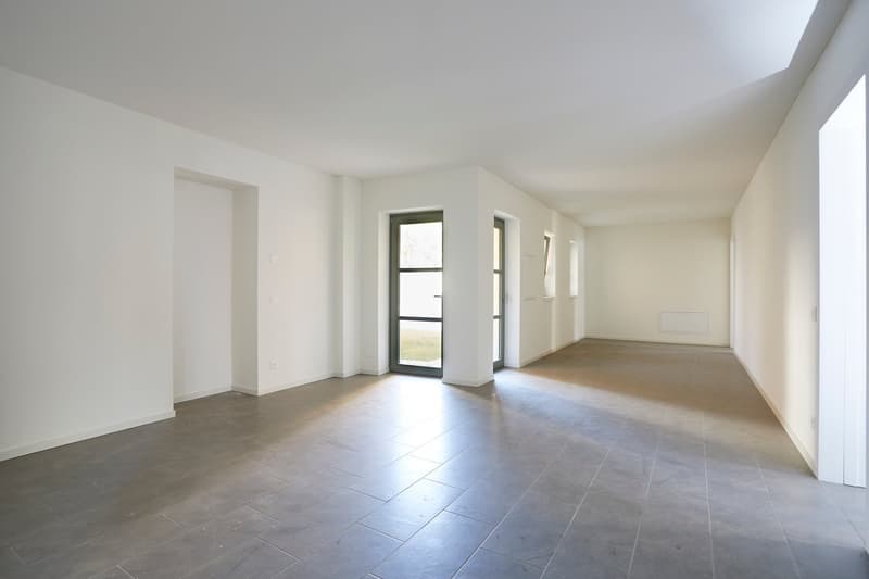 Empty room, white walls, tiled floor, glass doors, no furniture