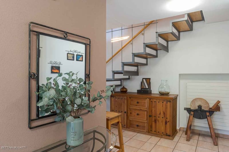 tiled floor, mirror, cabinet, stairs, plant, wooden stool
