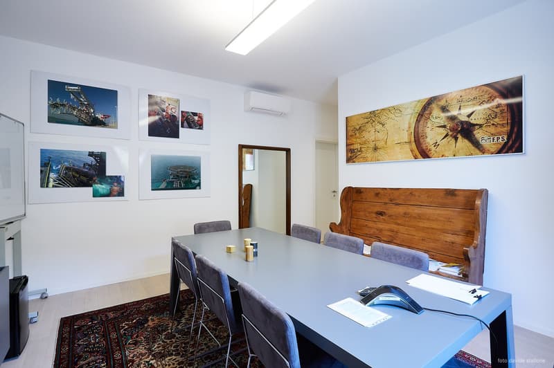 large table, gray chairs, carpet, pictures on wall, wooden bench, mirror, air conditioner