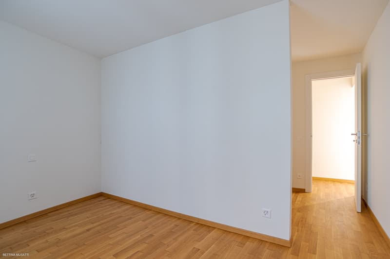 empty room, wooden floor, white walls, doors leading to another room