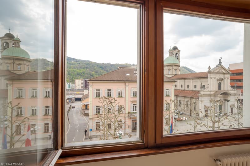 View from the window to the outside buildings and a road, a person walking
