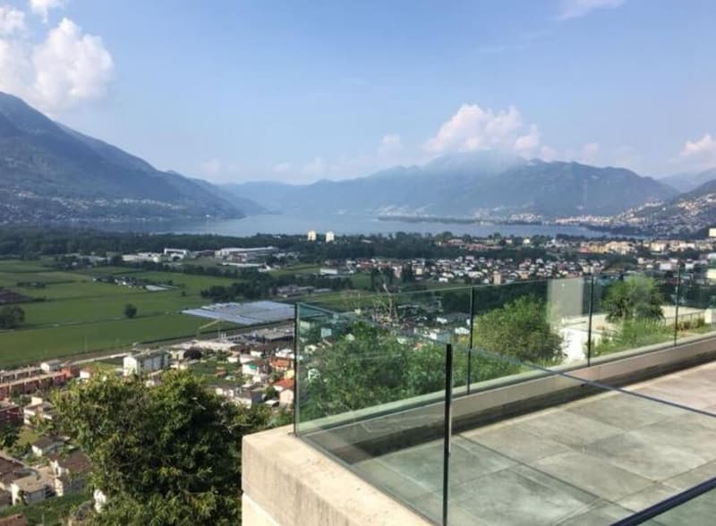 Glass wall balcony, paved terrace, mountain and lake view