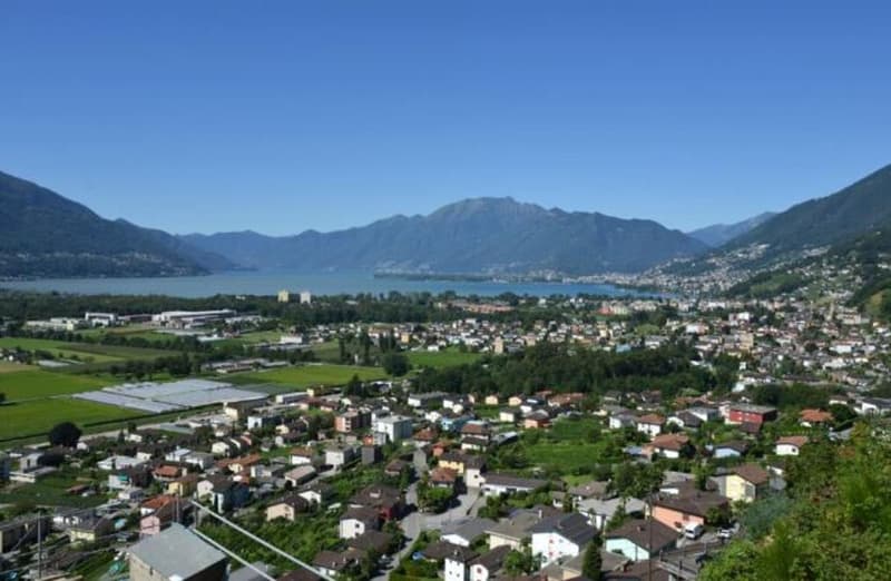 Aerial view of houses, mountains, lake, sky