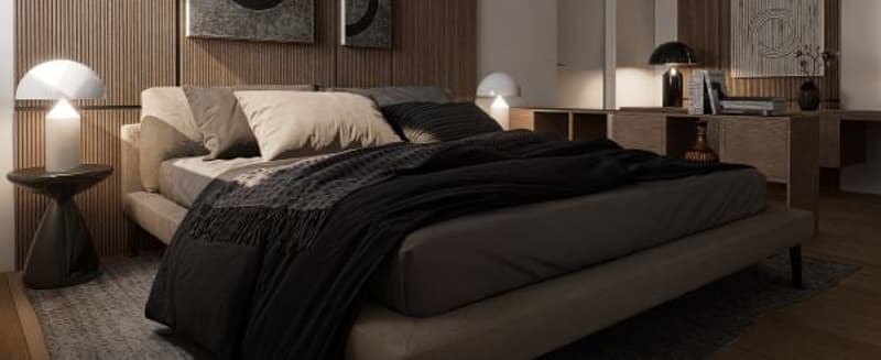 Spacious bedroom with a large bed, dark bedding, and wooden furniture. The room has a cozy and modern feel with wall paneling and lighting fixtures.