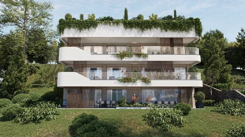 3-story modern apartment building with white walls, wooden balcony railings, and lush greenery surrounding it. The building has multiple balconies on each floor.