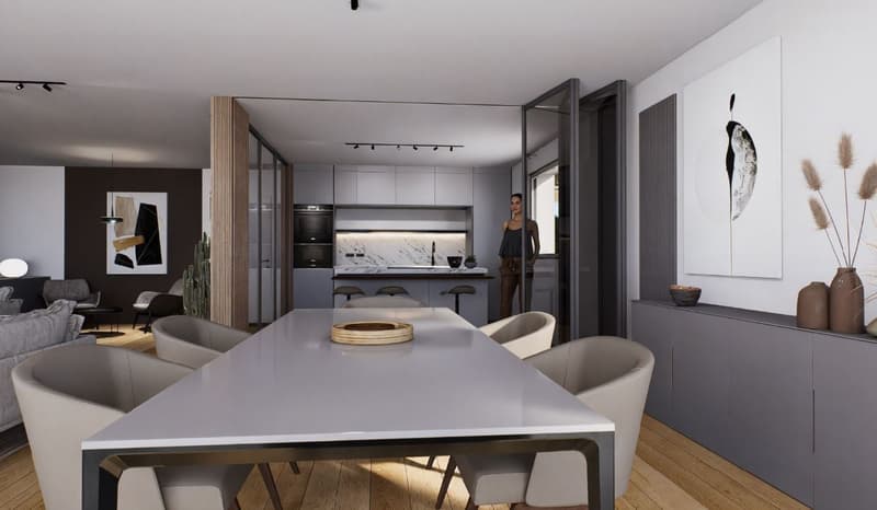The image shows an open-plan living area with a modern kitchen, dining table, and living room. The kitchen features sleek gray cabinets, a marble backsplash, and built-in appliances including a dishwasher. The dining table is surrounded by comfortable cha