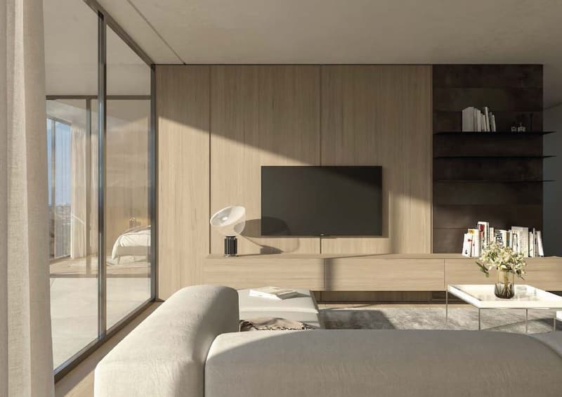 Spacious living room with large windows, wooden wall panels, TV unit, shelving, and a couch