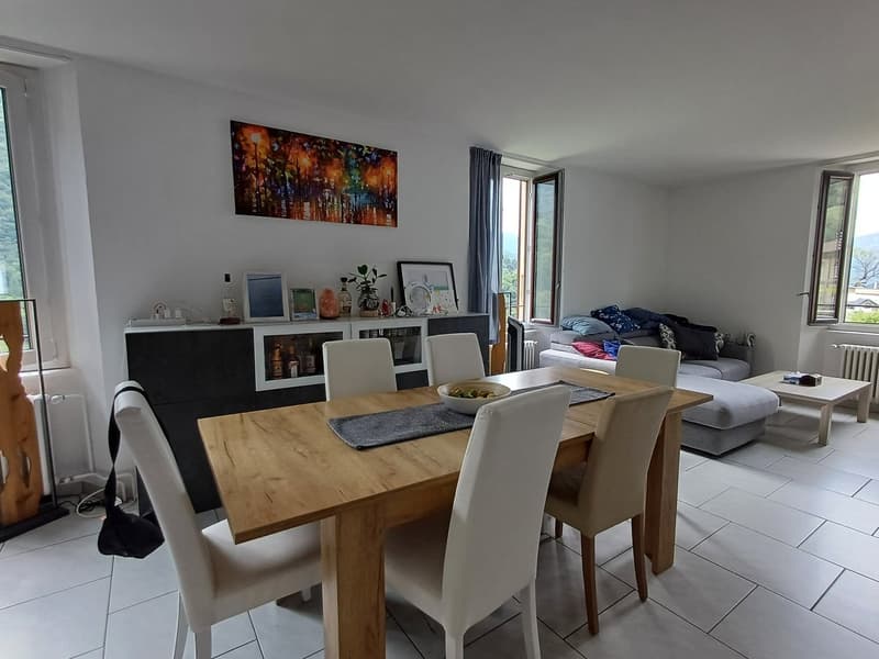 dining room, wooden table, 4 chairs, painting on wall, coffee table, sideboard, couch, window, radiator