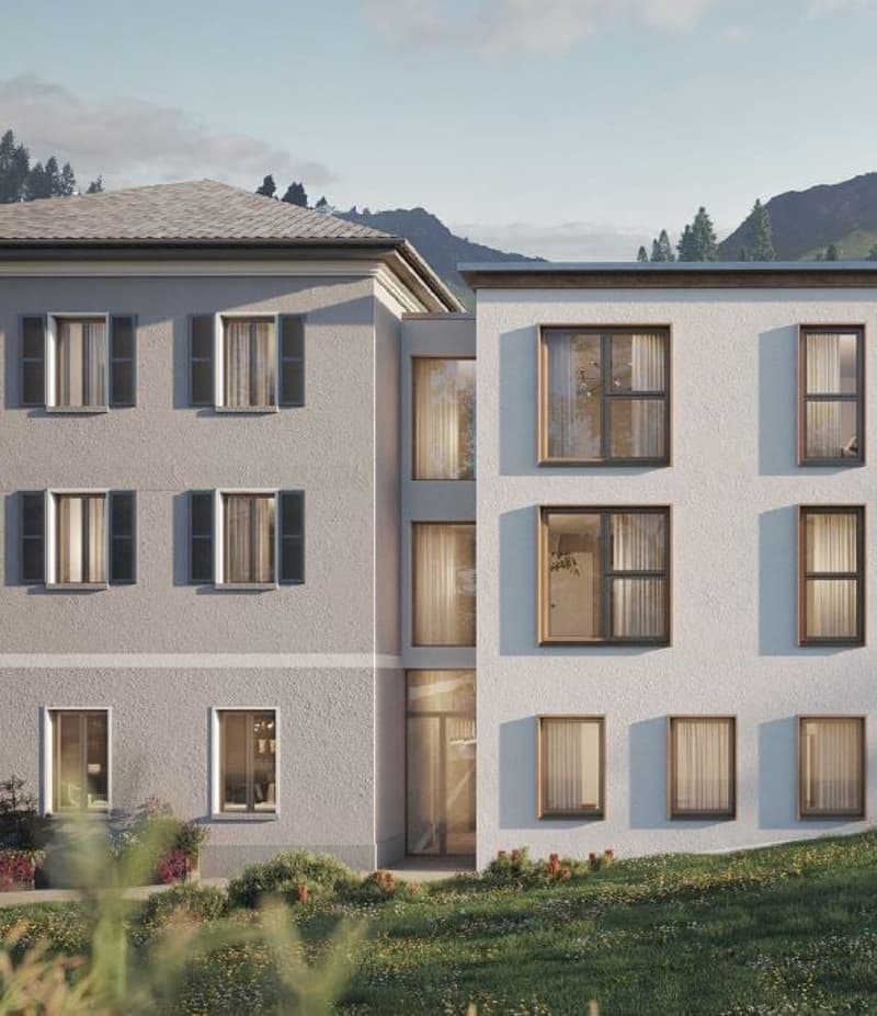 3 story modern apartment building, white exterior, multiple windows, surrounded by greenery, mountains in the background