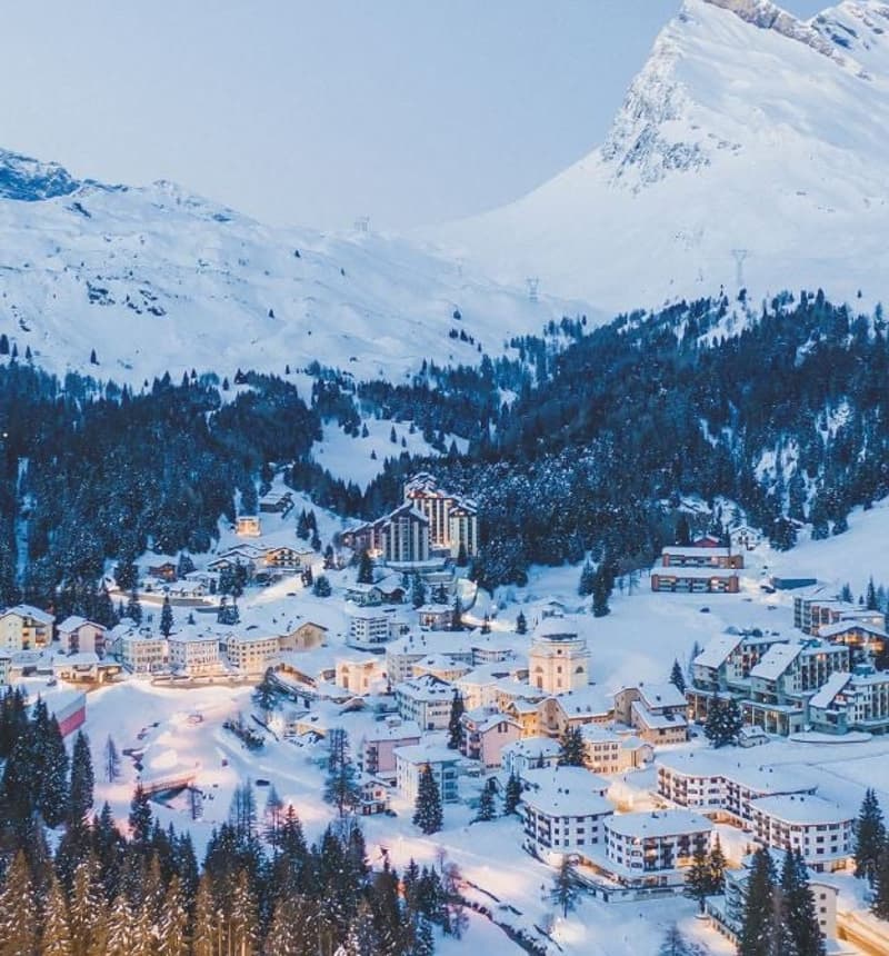Snow-covered mountainous area with buildings
