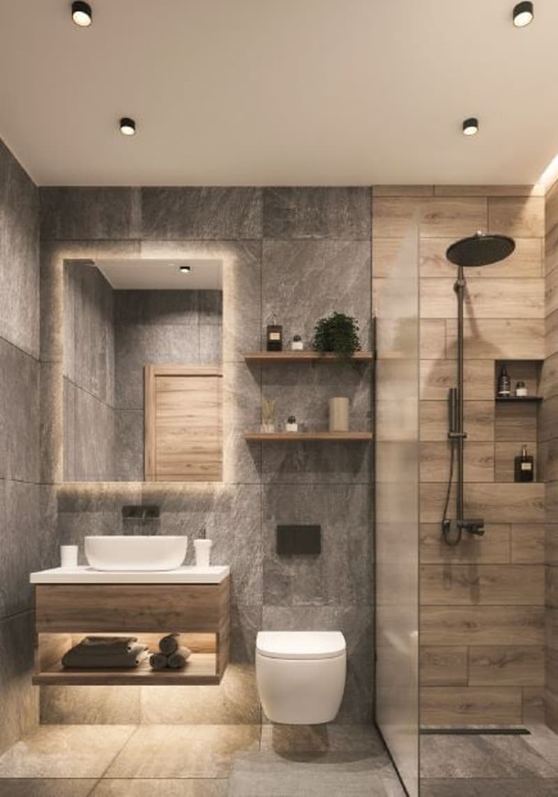 Bathroom with white sink, toilet, and shower area. Wood walls, tiled floor, and modern design.