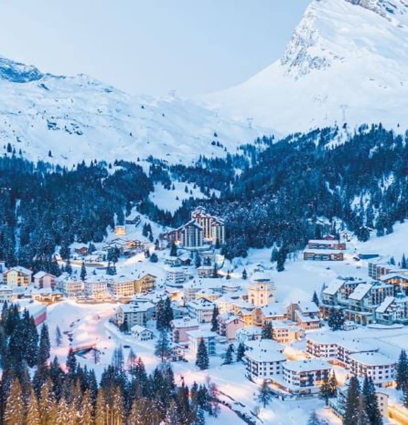 Village in the mountain, covered in snow, multiple buildings, scenic