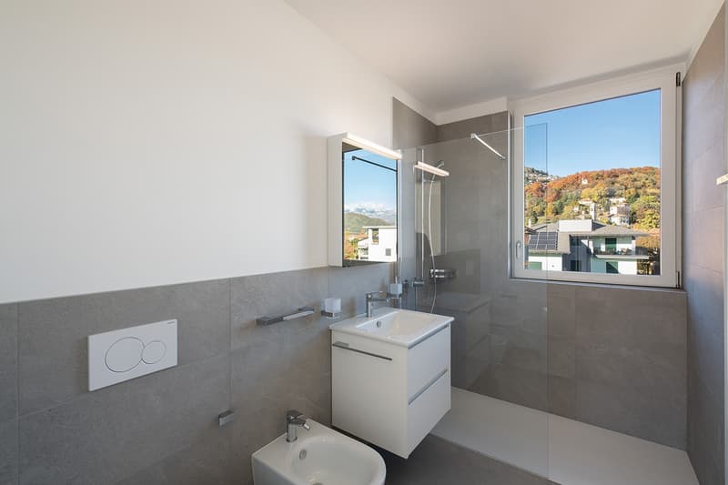 modern bathroom, white sink, glass shower, white tiles, window with view
