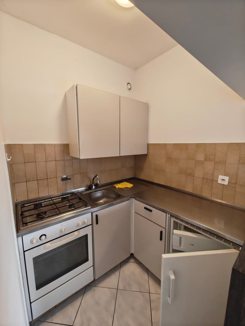 white cabinets, tiled floor, gas stove, oven, sink, dishwasher, power outlet