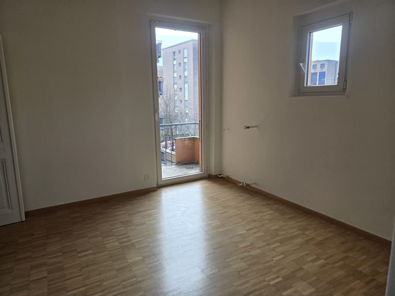 Empty room with balcony, wooden floor, glass door, glass window