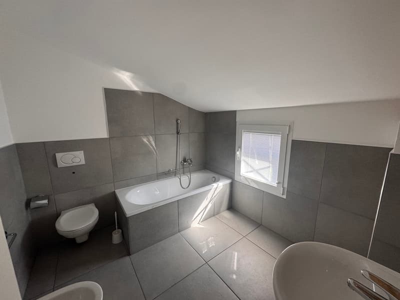 modern bathroom with bathtub, toilet, bidet, and sink
