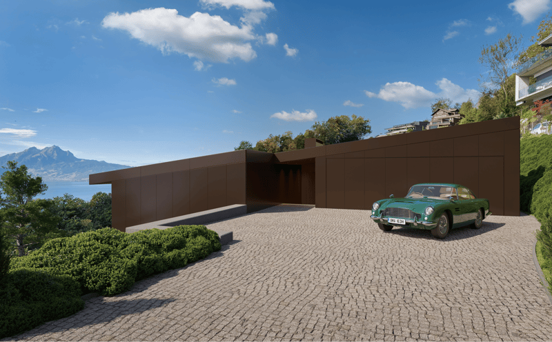 Modern house with brown exterior, large driveway, green car parked, surrounded by greenery, mountain view