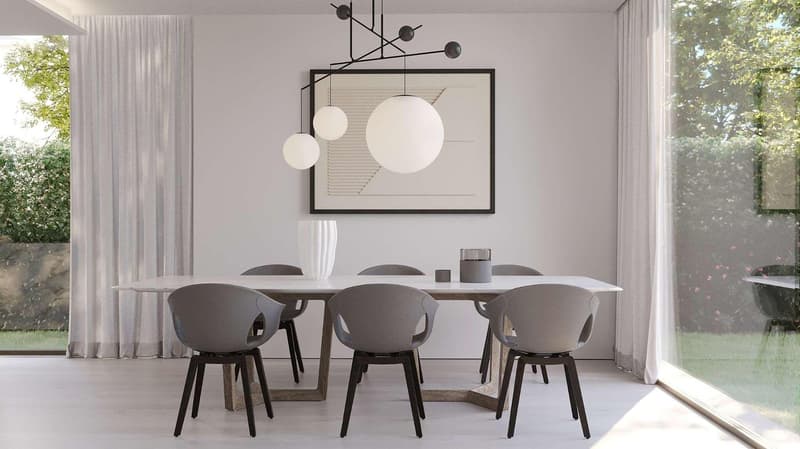 Dining room with a large table, modern chairs, a white vase, a picture frame, and a chandelier