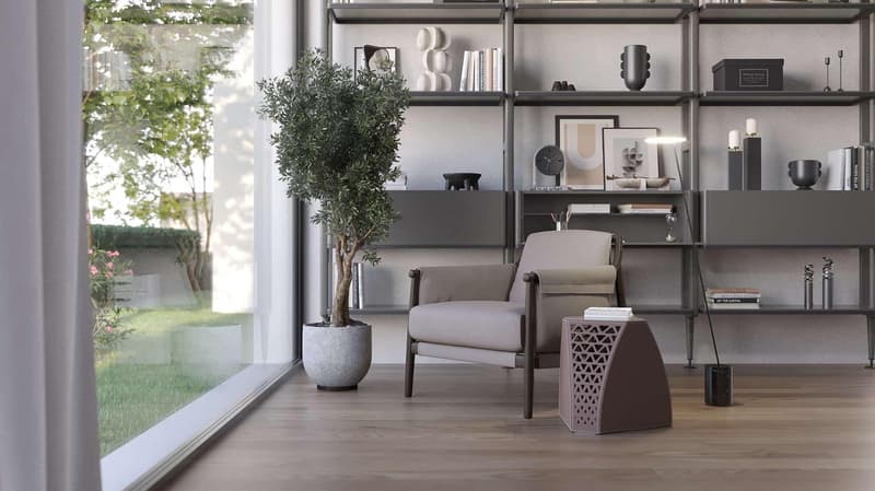 modern living room with a chair, a potted plant, a shelf with books and decorative items, and a large window with a view of a garden