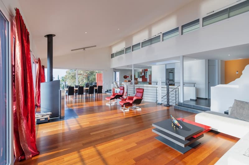 modern open floor plan, hardwood floors, glass windows, dining area, modern kitchen, two red chairs